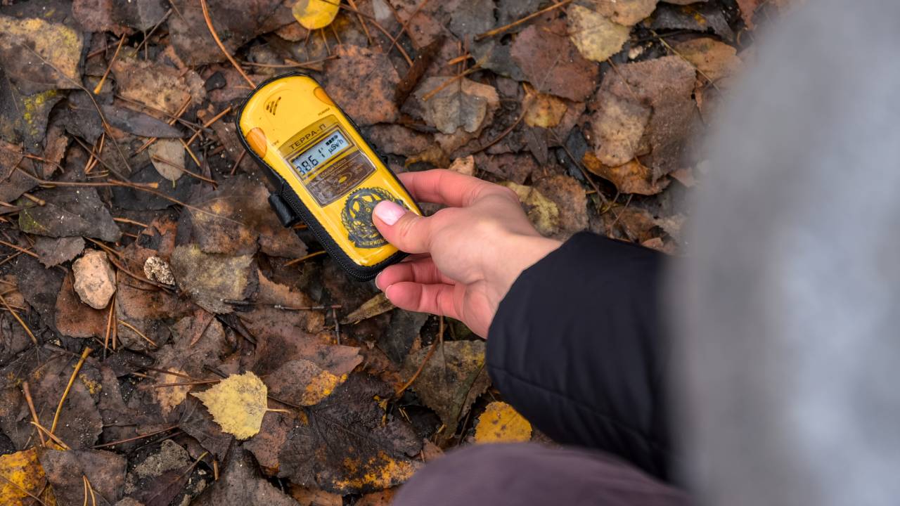 man holding geiger counter